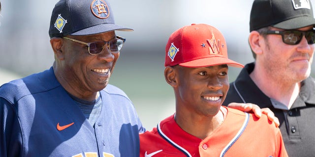 Houston Astros manager Dusty Baker poses with his son, Washington Nationals minor league player Darren Baker, after exchanging lineups before a spring training game at The Ballpark of The Palm Beaches March 19, 2022, in West Palm Beach, Fla.