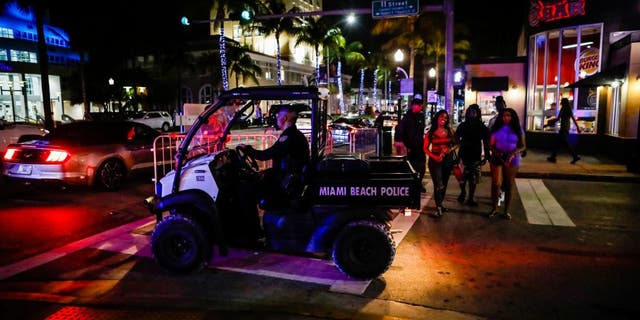 A Miami Beach Police officer exits a closed road during Spring Break in Miami Beach, Florida, on March 24, 2022. 