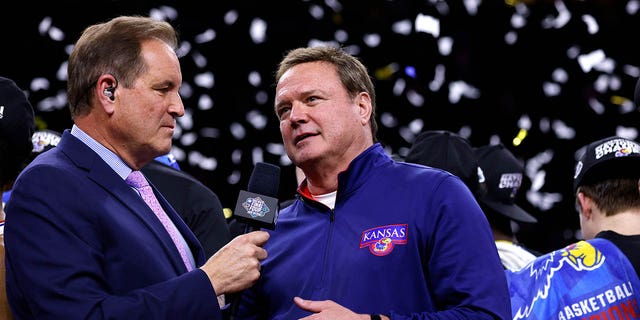 Jim Nantz, left, interviews Kansas Jayhawks head coach Bill Self following their victory against the North Carolina Tar Heels during the 2022 NCAA Men's Basketball Tournament Final Four Championship at Caesars Superdome on June 4 April 2022 in New Orleans.