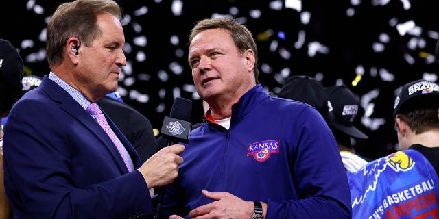 Jim Nantz, left, interviews Kansas Jayhawks head coach Bill Self following their victory against the North Carolina Tar Heels during the 2022 NCAA Men's Basketball Tournament Final Four Championship at Caesars Superdome on April 4, 2022 in New Orleans.