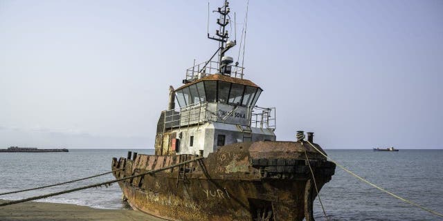 A stranded fishing boat on a sandy beach in the Gulf of Guinea off West Africa Feb. 6, 2022.