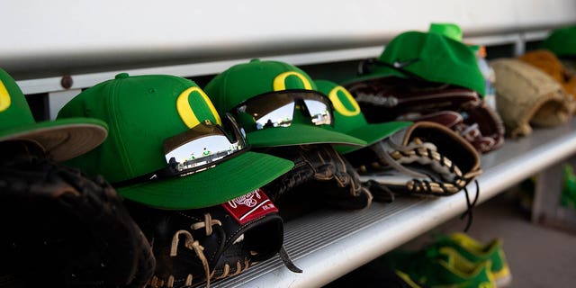 Oregon Ducks hats line the dugout during the PAC12 Baseball Tournament on May 25, 2022, in Scottsdale, Arizona.