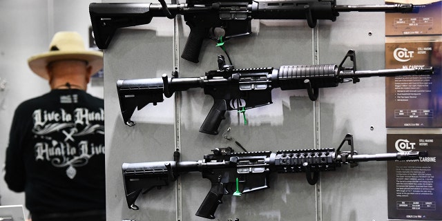 Colt M4 Carbine and AR-15 style rifles are displayed during the National Rifle Association (NRA) Annual Meeting at the George R. Brown Convention Center, in Houston on May 28, 2022. 