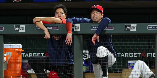 Kenta Maeda, #18 of the Minnesota Twins, and his translator look on against the Chicago White Sox in the eighth inning at Target Field on July 14, 2022 in Minneapolis. The White Sox defeated the Twins 12-2. 