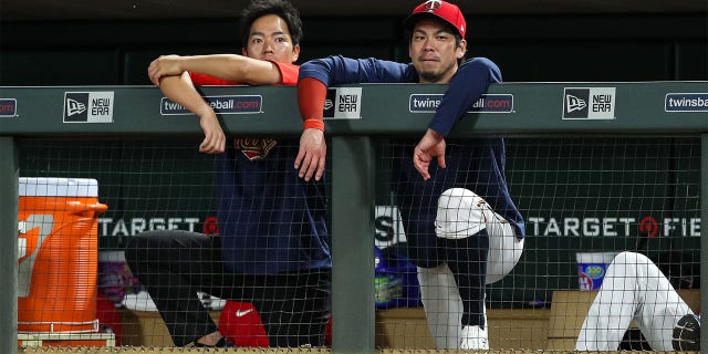 Kenta Maeda, #18 of the Minnesota Twins, and his translator look on against the Chicago White Sox in the eighth inning at Target Field on July 14, 2022 in Minneapolis. The White Sox defeated the Twins 12-2. 