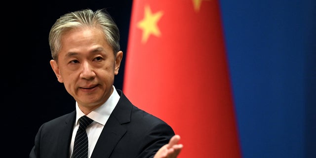 Chinese Foreign Ministry spokesman Wang Wenbin gestures during a press conference at the Ministry of Foreign Affairs in Beijing on August 8, 2022.