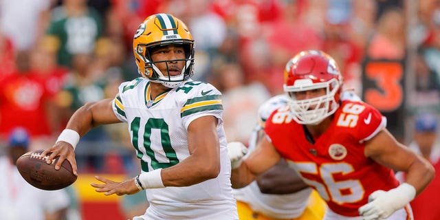 Jordan Love (10) of the Green Bay Packers throws a pass in the first quarter with pressure from George Karlaftis (56) of the Kansas City Chiefs during a preseason game at Arrowhead Stadium Aug. 25, 2022, in Kansas City, Mo. 