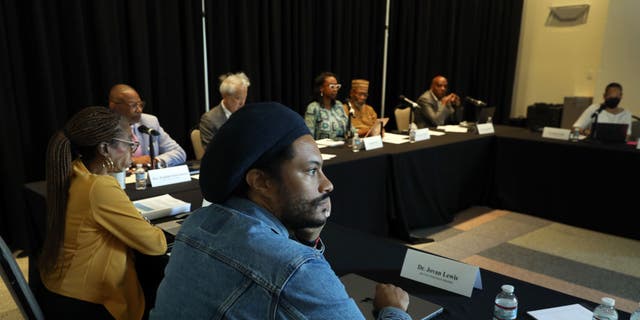 Dr. Jovan Lewis, center, listens as the California Reparations Task Force meets to hear public input on reparations at the California Science Center in Los Angeles Sept. 22, 2022. 