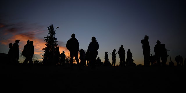 Venezuelan migrants communicate with their families and friends at the camp area in front of the US Border Patrol operations post across the Rio Bravo River in the evening hours in Mexico on November 14, 2022. 