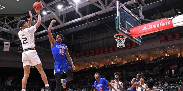 Miami guard Isaiah Wong shoots a jump shot over St. Francis guard Roy Clarke on Nov. 23, 2022, at the Watsco Center in Coral Gables, Florida.