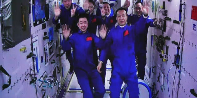 This image captured at the Jiuquan Satellite Launch Center in northwest China shows the Shenzhou-15 and Shenzhou-14 crew waving after a historic gathering in space on Nov. 30, 2022. The three astronauts aboard China's Shenzhou-15 spaceship entered the country's space station and met with another astronaut trio on Wednesday, a historic gathering that added the manpower at the in-orbit space lab to six for the first time.