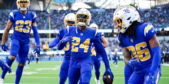 The Los Angeles Chargers celebrate an interception by safety Nasir Adderley (24) during the second half against the Tennessee Titans at SoFi Stadium on Sunday, Dec. 18, 2022 in Los Angeles, CA.