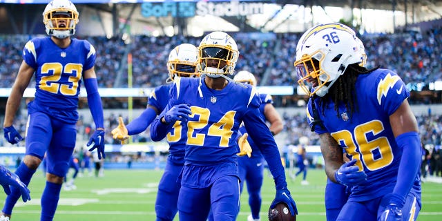 The Los Angeles Chargers celebrate an interception by safety Nasir Adderley (24) during the second half against the Tennessee Titans at SoFi Stadium on Sunday, Dec. 18, 2022 in Los Angeles, CA.