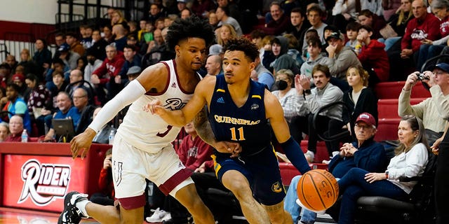 Quinnipiac Bobcats guard Dezi Jones (11) dribbles the ball against Rider Broncs guard Corey McKeithan (3) during the first half of a game on January 6, 2023, at Alumni Gymnasium in Lawrenceville , New Jersey.