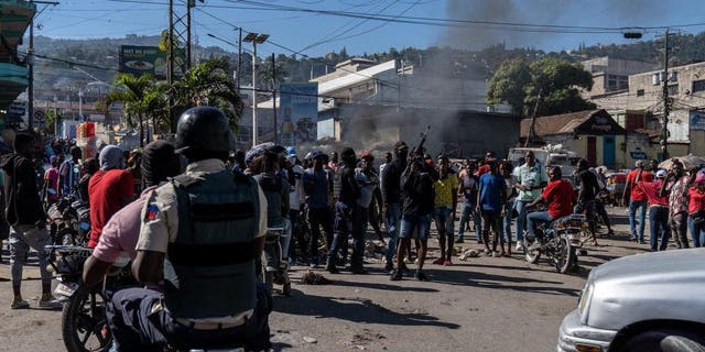 Armed police officers protest after a gang attack on a police station that left six officers dead in Port-au-Prince, Haiti, Jan. 26, 2023.