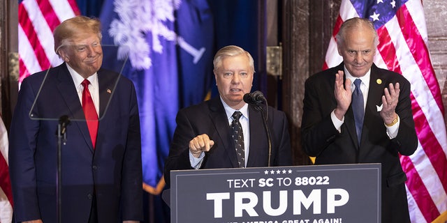 South Carolina GOP Sen. Lindsey Graham speaks as former President Donald Trump, left, and Henry McMaster, South Carolina's governor, listen during a campaign event in Columbia, South Carolina, on Jan. 28, 2023.