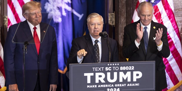 South Carolina GOP Sen. Lindsey Graham speaks as former President Donald Trump, left, and Henry McMaster, South Carolina's governor, listen during a campaign event in Columbia, South Carolina, on Jan. 28, 2023.