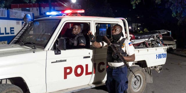 Police officers patrol a street during a vigil in memory of three police officers killed by armed gangs in Petion-Ville, Port-au-Prince, Haiti, January 30, 2023.