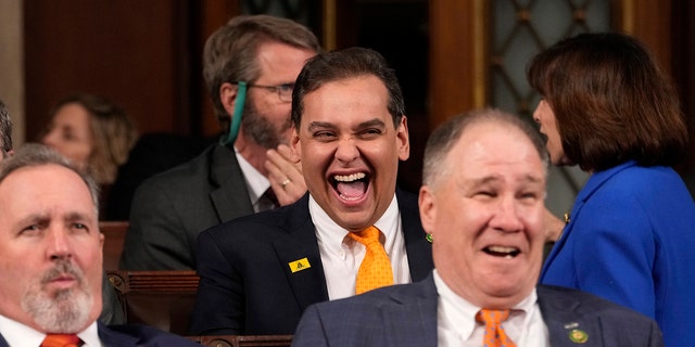 Rep. George Santos, seen laughing ahead of a Biden's State of the Union address last month, is now facing a formal House Ethics investigation. 