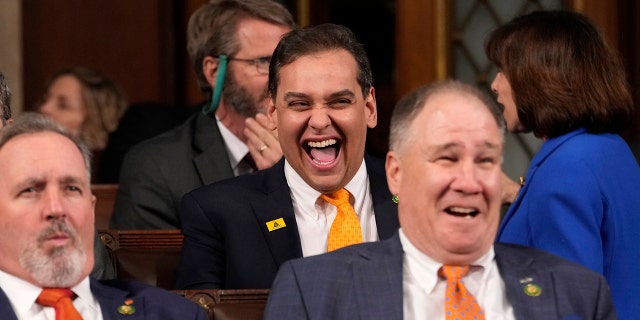 Rep. George Santos, seen laughing ahead of a Biden's State of the Union address last month, is now facing a formal House Ethics investigation. 