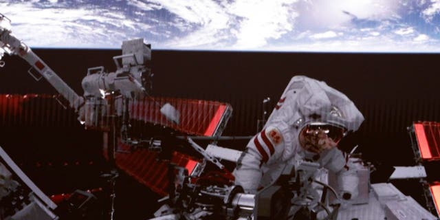 This screen image captured at Beijing Aerospace Control Center on Feb. 9, 2023, shows Shenzhou-15 taikonaut Fei Junlong returning to space station lab module Wentian after finishing extravehicular activitiesEVAs. The Shenzhou-15 taikonauts on board the orbiting Chinese Tiangong space station completed their first spacewalk at 12:16 a.m. Beijing Time on Friday, according to the China Manned Space Agency.