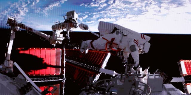 This screen image captured at the Beijing Aerospace Control Center on Feb. 9, 2023, shows Shenzhou-15 taikonaut Fei Junlong returning to the Wentian Space Station's laboratory module with equipment.  The Shenzhou-15 taikonauts aboard China's orbiting space station Tiangong completed their first spacewalk on Friday at 00:16 Beijing time, according to the China Manned Space Agency. 