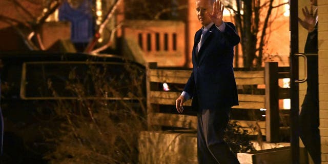 President Joe Biden waves to reporters as he departs following dinner at the Red Hen restaurant in Washington, D.C., on Feb. 18, 2023.