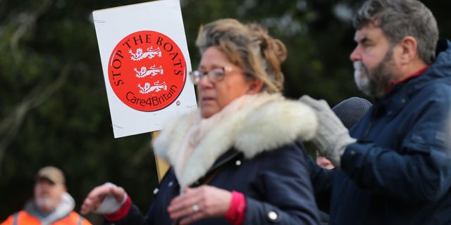 A protester holds a sign saying "Stop the Boats" as protesters listen to speeches on Feb. 25, 2023 in Skegness, England.