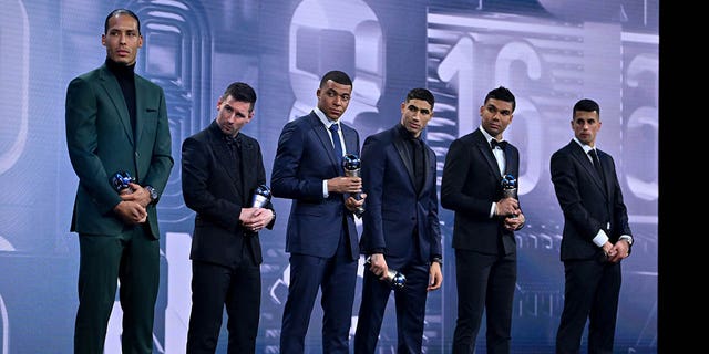 Players included in the FIFA FIFPRO Men's World 11 2022 Team, from left, Virgil van Dijk, Lionel Messi, Kylian Mbappe, Achraf Hakimi, Casemiro and Joao Cancelo with their trophies during The Best FIFA Football Awards 2022 at Salle Pleyel on 27 January February.  2023 in Paris.