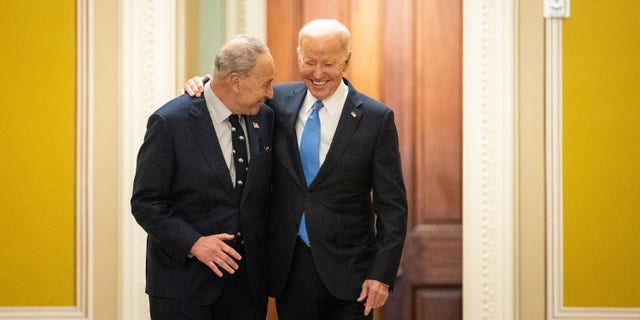 WASHINGTON, DC - MARCH 02: President Joe Biden walks with Senate Majority Leader Chuck Schumer (D-NY) as they arrive at the US Capitol on Thursday.