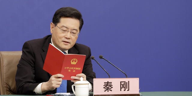 Qin Gang, China's foreign minister, speaks while holding a copy of the constitution during a news conference in Beijing Tuesday, March 7, 2023. President Xi Jinping sought to rally China's private sector to help overcome "containment" by the US and other countries, in rare direct criticism of the nation's biggest trading partner.