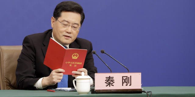 Qin Gang, China's foreign minister, speaks while holding a copy of the constitution during a news conference in Beijing Tuesday, March 7, 2023. President Xi Jinping sought to rally China's private sector to help overcome "containment" by the US and other countries, in rare direct criticism of the nation's biggest trading partner.