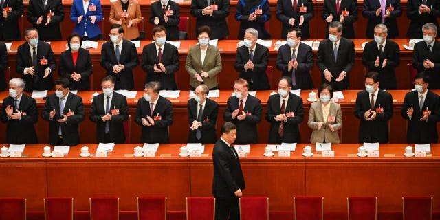 China's President Xi Jinping, bottom center, arrives for the second plenary session of the National People's Congress with other Chinese leaders at the Great Hall of the People in Beijing on March 7, 2023.