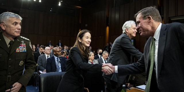 Avril Haines, director of national intelligence, shakes hands with Sen. Mark Warner, Democrat chairman of the Senate Intelligence Committee, on March 8, 2023. Haines testified on threats from China, Russia and North Korea.