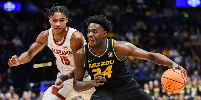 Kobe Brown #24of the Missouri Tigers drives down the court against Noah Clowney #15 the Alabama Crimson Tide in the first half during the semifinals of the 2023 SEC Men's Basketball Tournament at Bridgestone Arena on March 11, 2023 in Nashville, Tennessee.