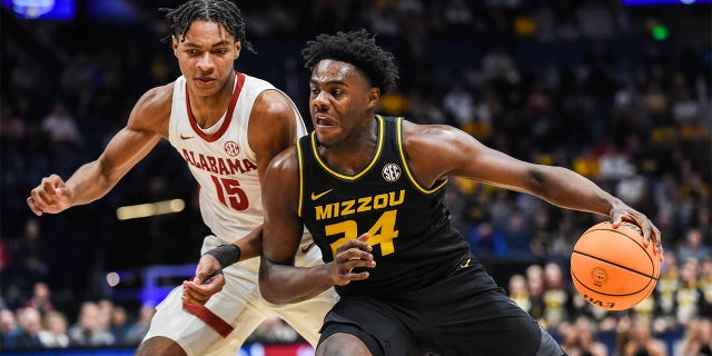 Kobe Brown #24of the Missouri Tigers drives down the court against Noah Clowney #15 the Alabama Crimson Tide in the first half during the semifinals of the 2023 SEC Men's Basketball Tournament at Bridgestone Arena on March 11, 2023 in Nashville, Tennessee.