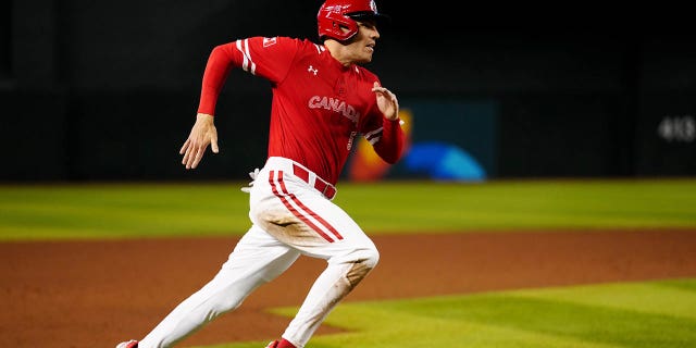 Freddie Freeman #5 of Team Canada scores a run in the third inning during Game 3 of Pool C between Team Great Britain and Team Canada at Chase Field on Sunday, March 12, 2023 in Phoenix, Arizona.