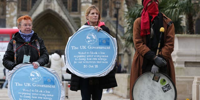 Activists protest the dumping of raw sewage in waterways, at Parliament Square on March 13, 2023, in London.