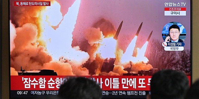 Inimesed seisavad 14. märtsil 2023 Souli raudteejaamas televiisori lähedal, kus näidatakse uudistesaadet Põhja-Korea raketikatsetusest.