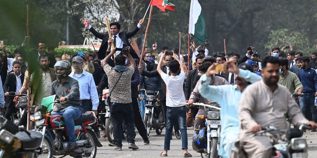 Supporters of former Pakistani Prime Minister Imran Khan block a road near Khan's home to prevent officers from arresting him in Lahore, Pakistan, on March 15, 2023.