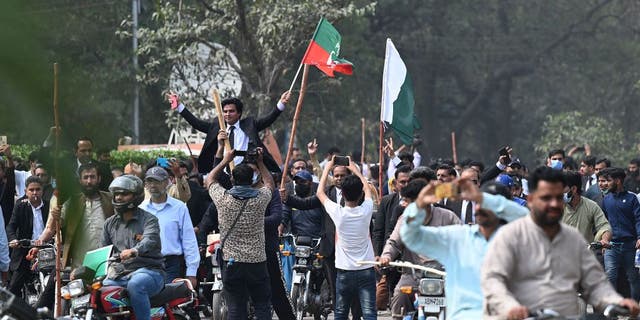 Supporters of former Pakistan Prime Minister Imran Khan block a road near Khan's residence to prevent officers from arresting him in Lahore, Pakistan, on March 15, 2023.