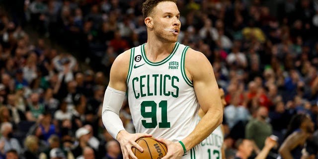 Blake Griffin, #91 of the Boston Celtics, gets the rebound in the third quarter of a game against the Minnesota Timberwolves at the Target Center on March 15, 2023 in Minneapolis.  The Celtics defeated the Timberwolves 104-102.