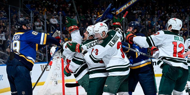 Jordan Pennington, #50 of the St. Louis Blues, poses with the Minnesota Wild at the Enterprise Center on March 15, 2023, in St. Louis, Missouri.
