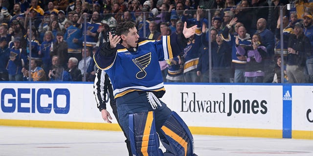 Jordan Binnington, #50 of the St. Louis Blues, pumps up the crowd during the game against the Minnesota Wild at the Enterprise Center on March 15, 2023, in St. Louis, Missouri. 