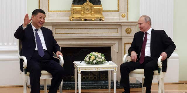 Russian President Vladimir Putin talks with Chinese President Xi Jinping in the Kremlin on March 20, 2023. 