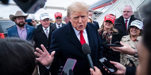 Former President Trump speaks with reporters as he lands at Quad City International Airport in route to Iowa on Monday, March 13, 2023, in Moline, Illinois.