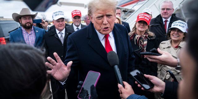 Former President Trump speaks with reporters as he lands at Quad City International Airport in route to Iowa on Monday, March 13, 2023, in Moline, Illinois.