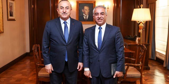 Turkish Foreign Minister Mevlut Cavusoglu (left) receives Barzani Charity Foundation President Musa Ahmad in Ankara, Turkey.
