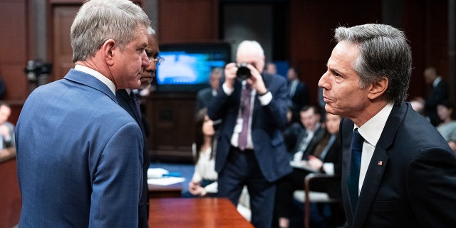Chairman Michael McCaul, R-Texas, left, and ranking member Gregory Meeks, D-N.Y., speak with Secretary of State Antony Blinken during the House Foreign Affairs Committee hearing on March 23, 2023.