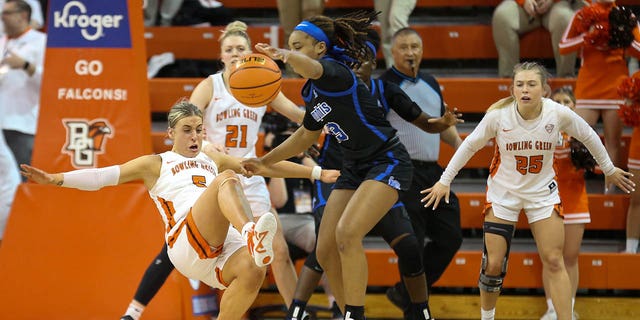 Bowling Green Falcons guard Elissa Brett (5) attempts to make a charge call against Memphis Tigers guard Jamirah Shutes (23) during a third round matchup of the Women's National Invitational Tournament between the Memphis Tigers and the Bowling Green Flacons on March 23, 2023 at the Stroh Center in Bowling Green, Ohio.